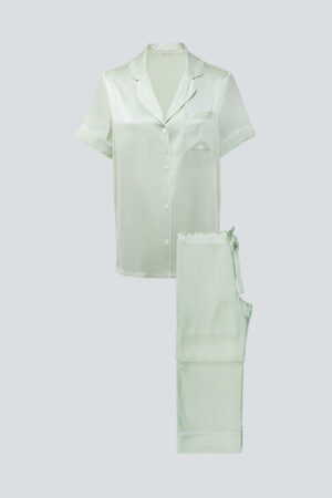 Flat lay of mint green MANITO Authentic Short Sleeve Pajama Set in soft silk with clean contrast piping.