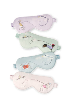 Four Puppy Silk Eyemasks in purple, green, blue, and pink, each with playful puppy and flowing leash motif for calming sleep.