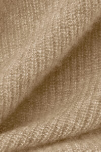 Close-up of Purity Knit Balaclava fabric, revealing the plush ribbed knit and airy, brushed texture.