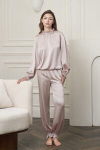 Model wearing the Purity Silk Women's Drawstring Set in lotus pink, showing the relaxed full-body silhouette and lantern sleeves.