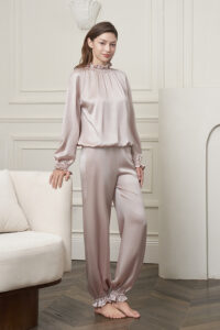 Model in the Purity Silk Women's Drawstring Set, featuring the smooth silk charmeuse drape and elegant ruffled cuffs.