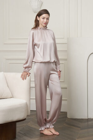 Model in the Purity Silk Women's Drawstring Set, featuring the smooth silk charmeuse drape and elegant ruffled cuffs.