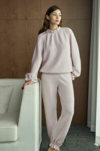 Woman wearing Purity Drawstring Set in lavender purple, standing by the sofa with a relaxed pose.