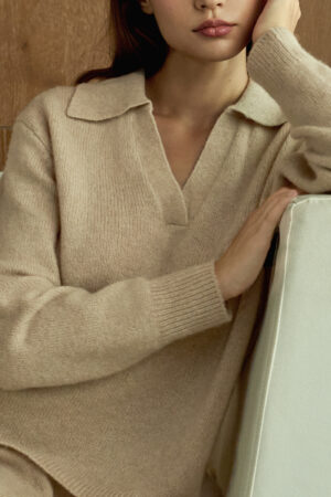 Close-up of woman wearing beige Purity Polo Knit Set, highlighting its soft texture and refined polo collar.