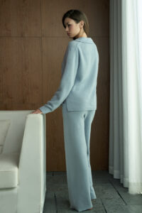 Back view of woman in blue Purity Polo Knit Set, showing the relaxed fit and smooth drape of the cashmere-silk blend.