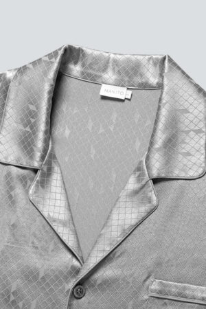 Fabric detail of MANITO Fragment Men's Pajama Set showing diamond jacquard silk collar and button.