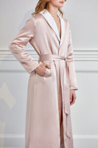 Close-up of the details of pink silk terry robe with contrasting white trim.