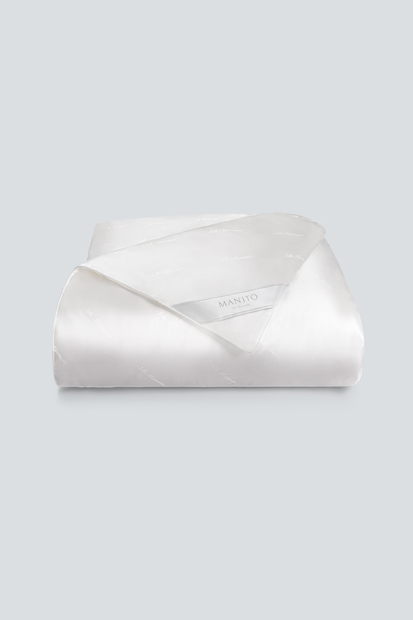 Gleam Silk Filled Duvet for all seasons, luxurious and hypoallergenic with Manito branding.
