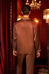 Back view of MANITO Ribbon Men's Long Sleeves Shirt in chestnut brown under warm lighting.