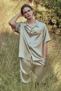 MANITO Remington Men's Silk Short Pajama Set in ginkgo, worn by a man in a natural outdoor setting.