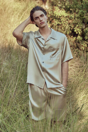 MANITO Remington Men's Silk Short Pajama Set in ginkgo, worn by a man in a natural outdoor setting.