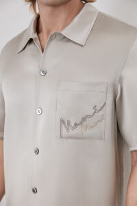 Chest pocket detail of MANITO Remington pajama top with embroidered logo.