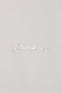 Detail of the subtle MANITO logo embroidery on Remington Short Sleeve Lounge Set, showcasing brand identity.