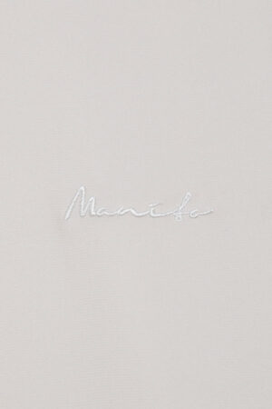 Detail of the subtle MANITO logo embroidery on Remington Short Sleeve Lounge Set, showcasing brand identity.