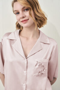Close-up of MANITO Remington Women's Silk Short Pajama Set showing embroidered pocket.