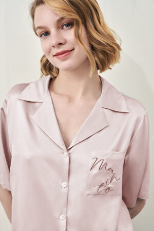 Close-up of MANITO Remington Women's Silk Short Pajama Set showing embroidered pocket.