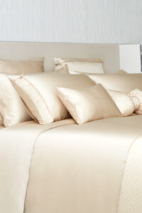 Side view of a neatly arranged bed covering MANITO Ribbon Silk bedding sets.