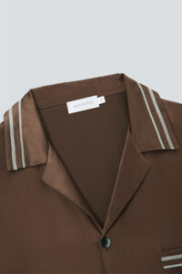 Close-up of brown MANITO Ribbon pajama collar with double stripe design.