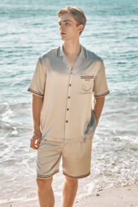 MANITO Ribbon Men's Short Pajama Set standing pose at the seaside, showing striped collar and cuffs.
