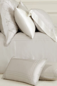 MANITO Ripple Bedding Set featuring intricately detailed silk pillowcases in neutral tones.