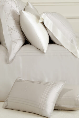 MANITO Ripple Bedding Set featuring intricately detailed silk pillowcases in neutral tones.