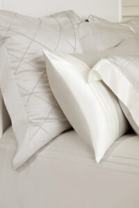 Detailed view of MANITO Ripple Bedding Set silk pillowcases, highlighting elegant stitching and luxurious textures.