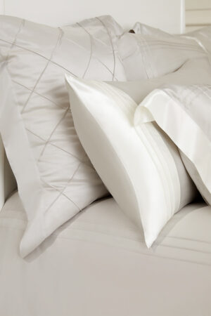 Detailed view of MANITO Ripple Bedding Set silk pillowcases, highlighting elegant stitching and luxurious textures.