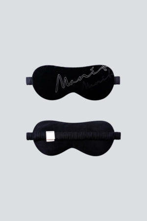 Black velvet eye mask featuring an embroidered MANITO logo, perfect for enhancing sleep quality.