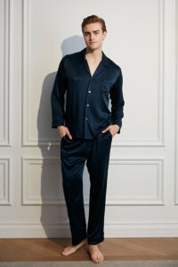 Model wearing navy MANITO Fragment Men's Pajama Set with button-down silk shirt and pants.