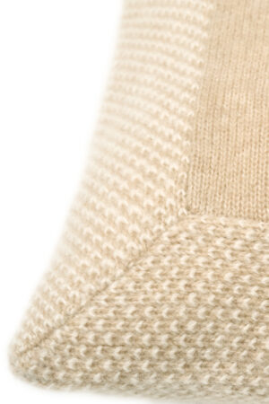 Detailed view of Sand Dune Knit Pillow edge, emphasizing the textured border and smooth surface.