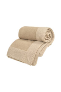 Folded Sand Dune Knit Throw Blanket, showing its dense knit structure and refined craftsmanship.
