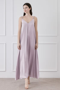 Model posing in Serene Silk Long Dress in Tanzanite, front view in a serene indoor setting.