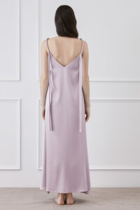 Back view of model in Serene Silk Long Dress in Tanzanite, showcasing the elegant flow and knotted straps.