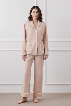A model is shown wearing Shell Women's Cashmere Pink Lounge Set at home, showcasing the relaxed fit.