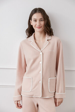 A model in Shell Women's Cashmere Pink Lounge Set featuring loose fit and cashmere fabrics.