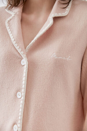 A close-up of Shell Women's Cashmere Pink Lounge Top, emphasizing the delicate embroidery and button details.