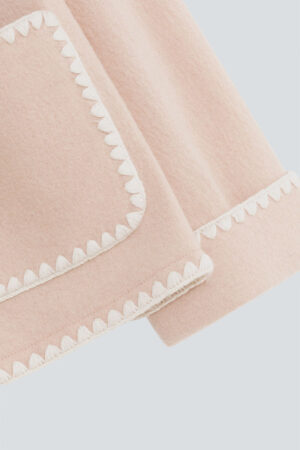 A detailed view of the scalloped edge on the cuffs of Shell Women's Cashmere Pink Lounge Top, showcasing the intricate design.