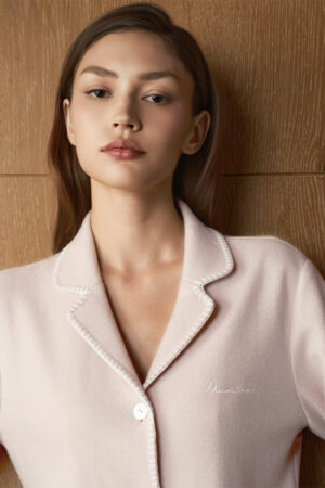 Close-up of MANITO Shell Women's Silk Wool Pajama Set in pink, showing collar and contrast embroidery edging.