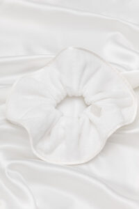 MANITO Silk Terry Scrunchie displayed on a smooth white surface, showcasing product view.
