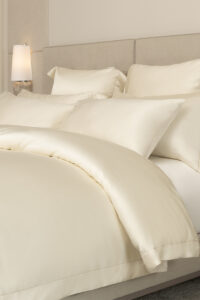 MANITO Silver Wire Silk Bedding Set featuring luxurious ivory silk duvet cover and matching pillowcases, styled elegantly in a serene bedroom.