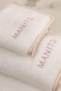 MANITO Soft Feeling 3 Pieces Bath Towel Set with detailed embroidery and beige silk trim, showcasing refined craftsmanship.