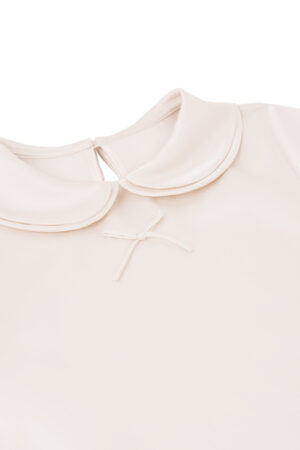 Close-up of MANITO Sophia Baby Romper showing soft doll collar and bow detail.