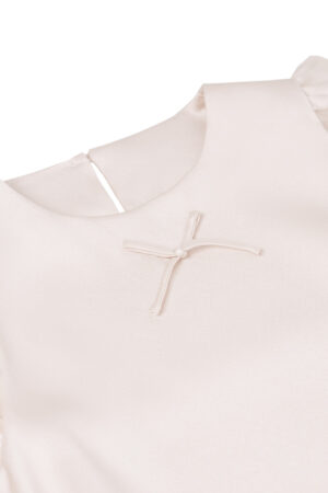 Close-up of MANITO Sophia Baby Sleeveless Romper with delicate silk bow on the chest.