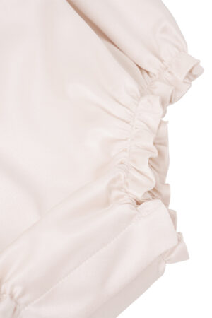 Bottom hem detail with elastic gathering on MANITO Sophia Baby Sleeveless Romper.