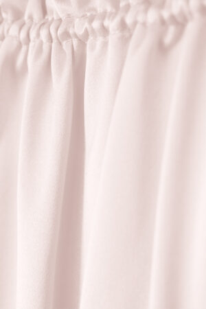 Elastic band detail of MANITO Sophia silk nightdress in an ballet pink color.