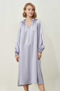 Ruffled neckline and loose lantern sleeves of MANITO Sophia silk nightdress in an orchid petal color.