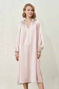 Mid-length, loose fit of MANITO Sophia silk nightdress in an ballet pink color from a front angle.
