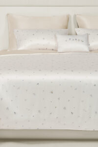 Sweet Garden Bedding Sets with Fitted Sheet-4 Pieces displayed on a bed with almond-beige silk and delicate floral motifs.
