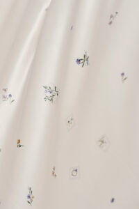 Sweet Garden Bedding Sets with Fitted Sheet-4 Pieces close-up of floral patterns and stamp-inspired MANITO details on silk fabric.