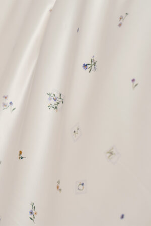 Sweet Garden Bedding Sets with Fitted Sheet-4 Pieces close-up of floral patterns and stamp-inspired MANITO details on silk fabric.